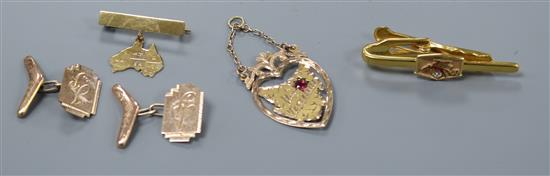 A pair of 9ct gold cufflinks with boomerang terminal, a 9ct gold map of Tasmania pendant, bar brooch and tie pin